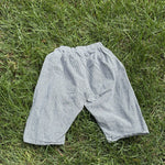 Pre-loved Aosta blue hickory stripe pull-on pants, kids size 2T, front view, laid flat on grass