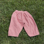 Pre-loved Aosta red hickory stripe pull-on pants, kids size 2T, front view, laid flat on grass
