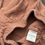 Pre-loved Aosta rust cotton gauze pull-on pants, kids size 2T, brand and size label close-up