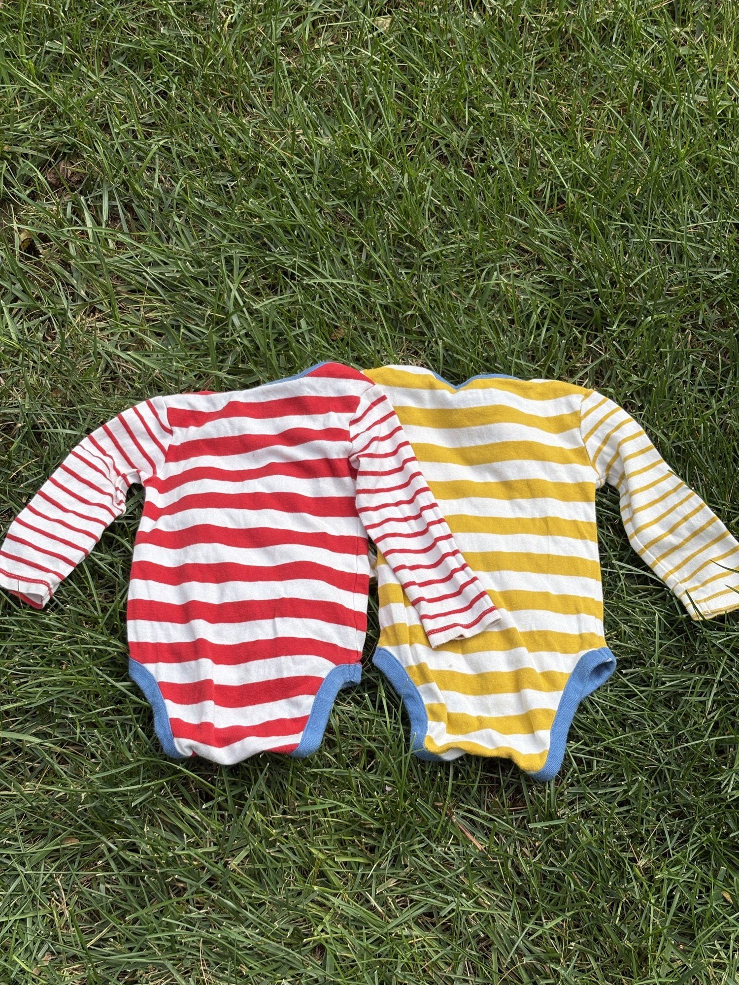 Pre-loved Boden red and yellow striped bodysuit 2-pack, kids size 12M, back view, laid flat on grass