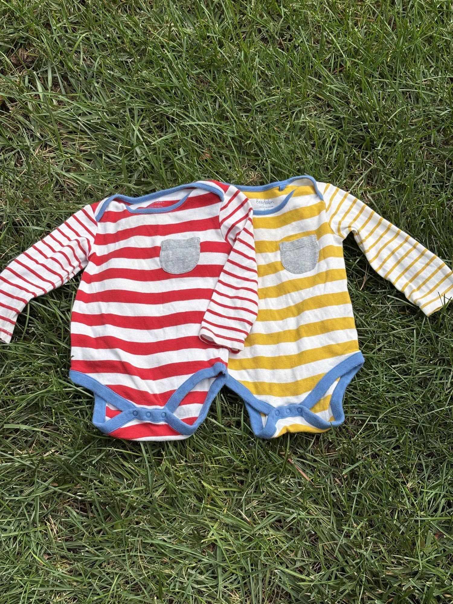 Pre-loved Boden red and yellow striped bodysuit 2-pack, kids size 12M, front view, laid flat on grass