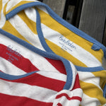 Pre-loved Boden red and yellow striped bodysuit 2-pack, kids size 12M, brand and size label close-up