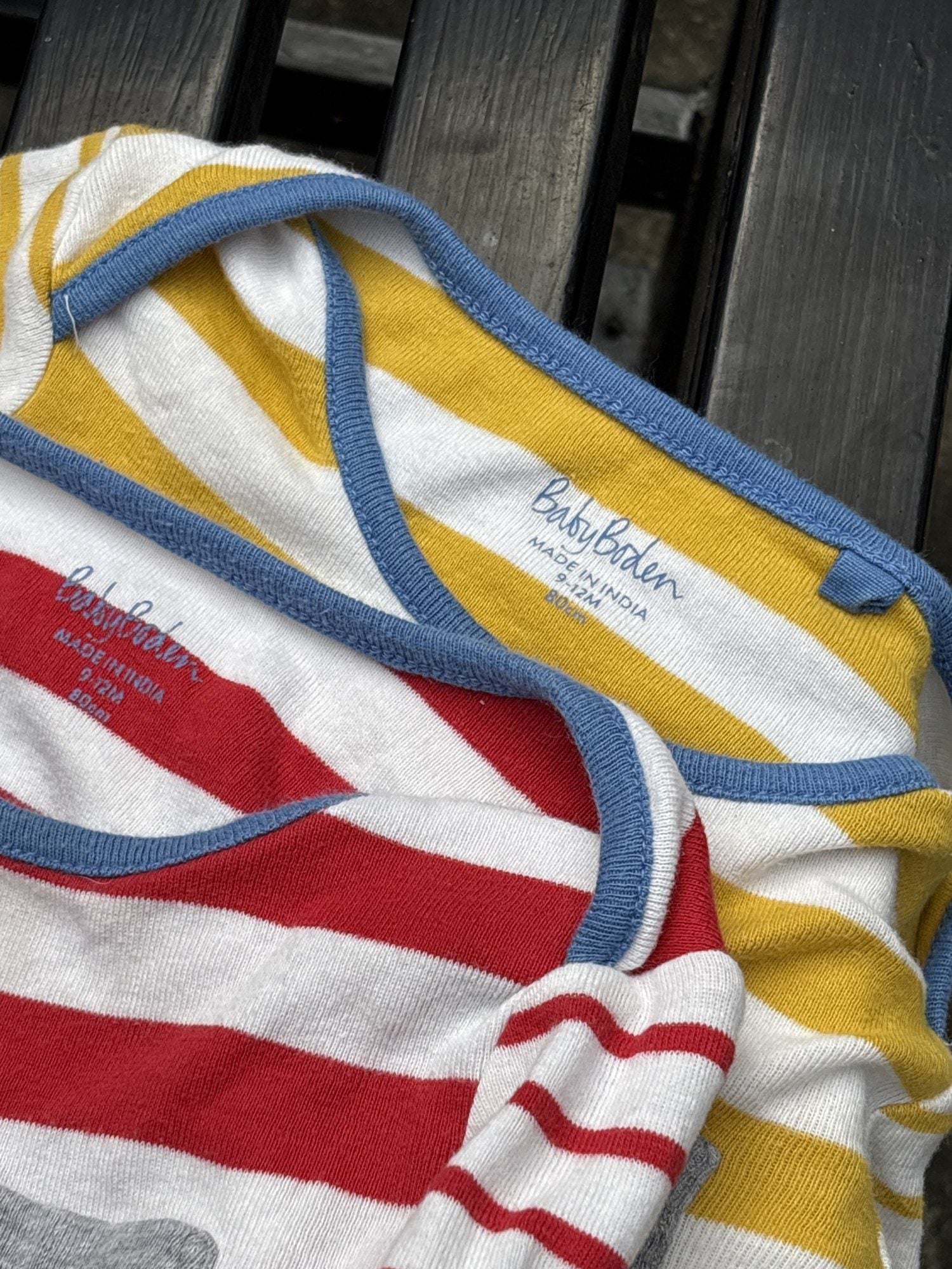 Pre-loved Boden red and yellow striped bodysuit 2-pack, kids size 12M, brand and size label close-up