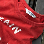 Pre-loved Boden red train graphic long-sleeve tee, kids size 6-12M, brand and size label close-up