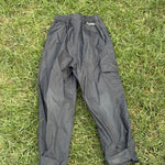 Pre-loved Columbia black pull-on rain pants, kids size 4/5, back view, laid flat on grass