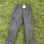 Pre-loved Columbia black pull-on rain pants, kids size 4/5, front view, laid flat on grass