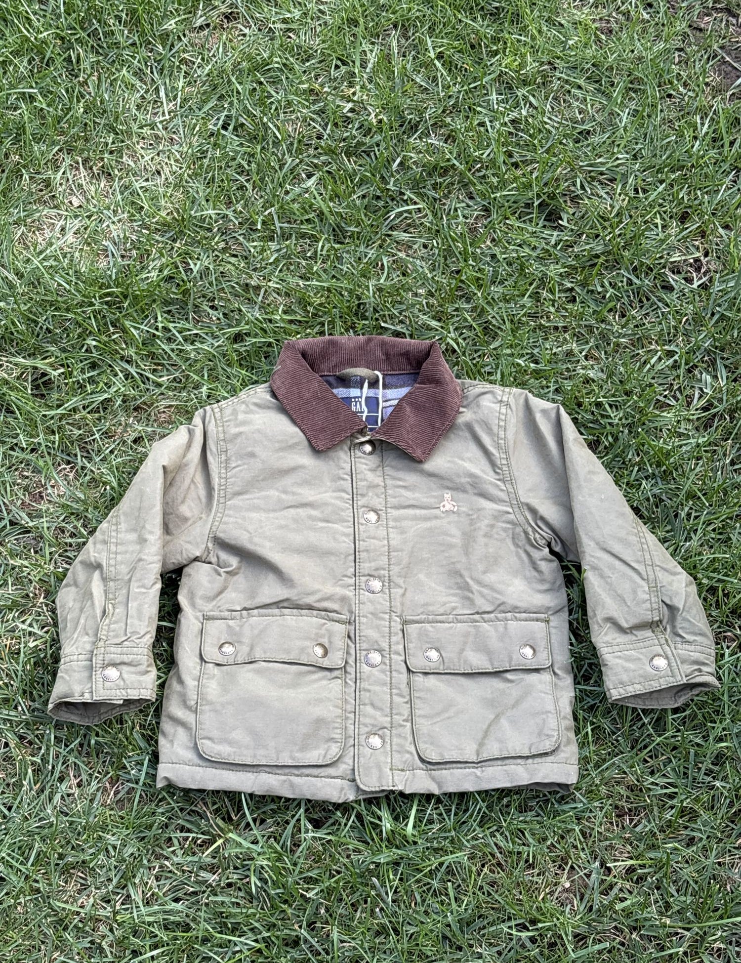 Pre-loved Gap khaki field jacket with corduroy collar, kids size 3T, front view, laid flat on grass