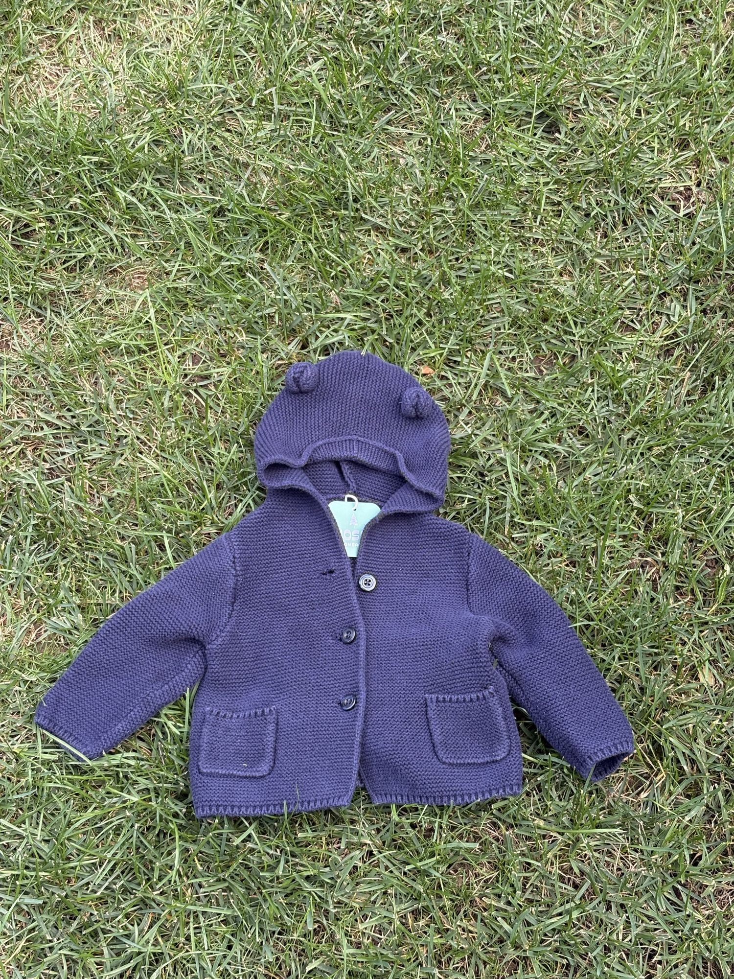 Pre-loved Gap navy bear-ear hooded knit cardigan, kids size 6-12M, front view, laid flat on grass