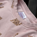 Pre-loved Hanna Andersson pink leopard print sweatshirt and jogger set, kids size 2T, brand and size label close-up