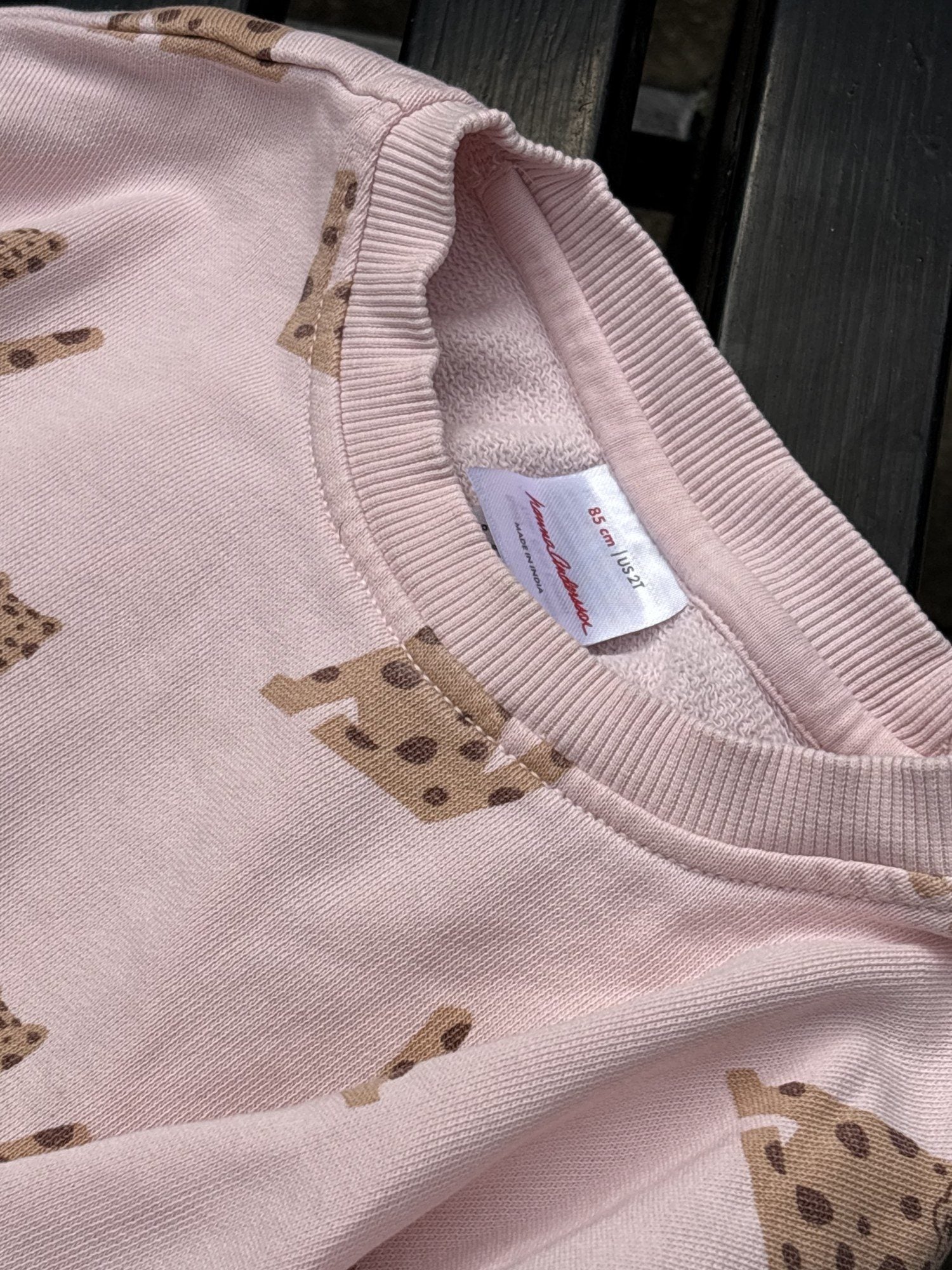 Pre-loved Hanna Andersson pink leopard print sweatshirt and jogger set, kids size 2T, brand and size label close-up