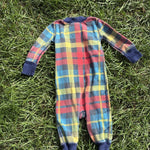 Pre-loved Hanna Andersson plaid organic cotton zip sleeper, kids size 6-12M, back view, laid flat on grass