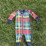 Pre-loved Hanna Andersson plaid organic cotton zip sleeper, kids size 6-12M, front view, laid flat on grass