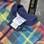 Pre-loved Hanna Andersson plaid organic cotton zip sleeper, kids size 6-12M, brand and size label close-up