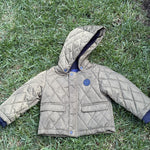 Pre-loved Jacadi olive quilted hooded jacket, kids size 18M, front view, laid flat on grass