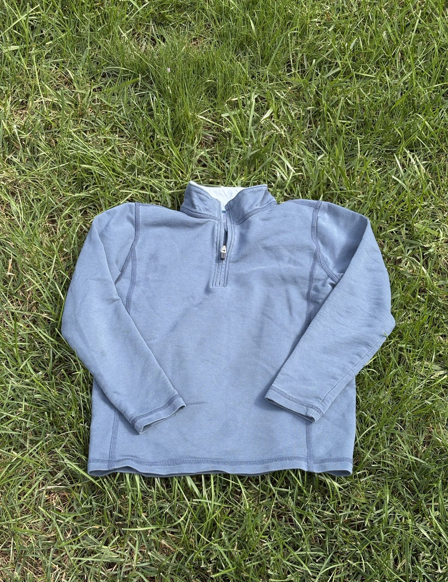 Pre-loved J.Crew blue performance quarter-zip pullover, kids size 6/7, front view, laid flat on grass