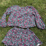 Pre-loved J.Crew green floral top and skirt set, kids size 10, back view, laid flat on grass