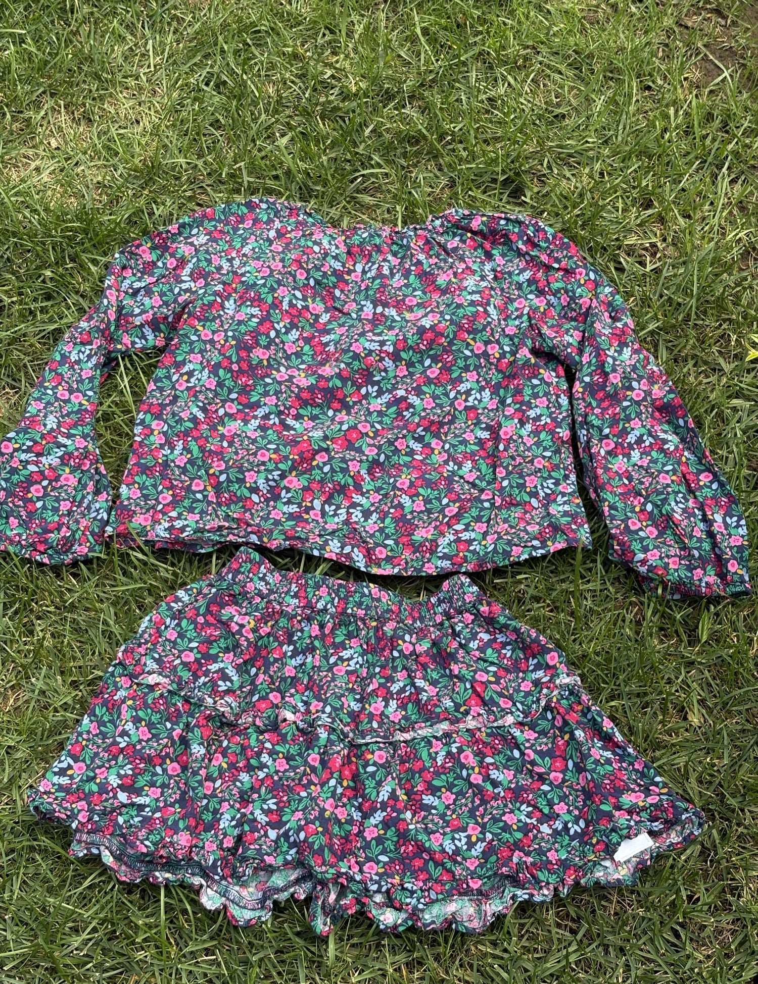 Pre-loved J.Crew green floral top and skirt set, kids size 10, back view, laid flat on grass