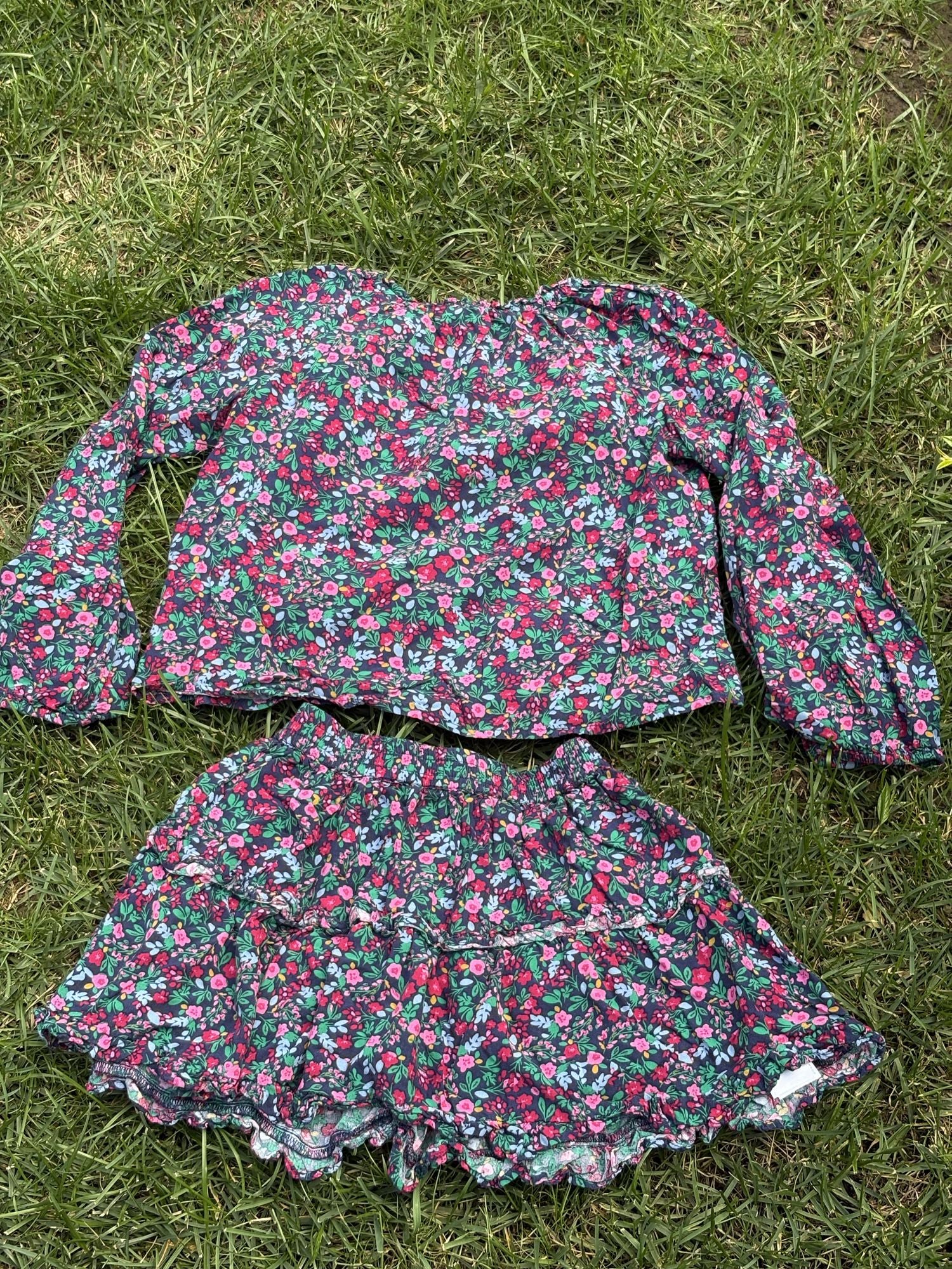Pre-loved J.Crew green floral top and skirt set, kids size 10, back view, laid flat on grass