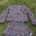 Pre-loved J.Crew green floral top and skirt set, kids size 10, front view, laid flat on grass