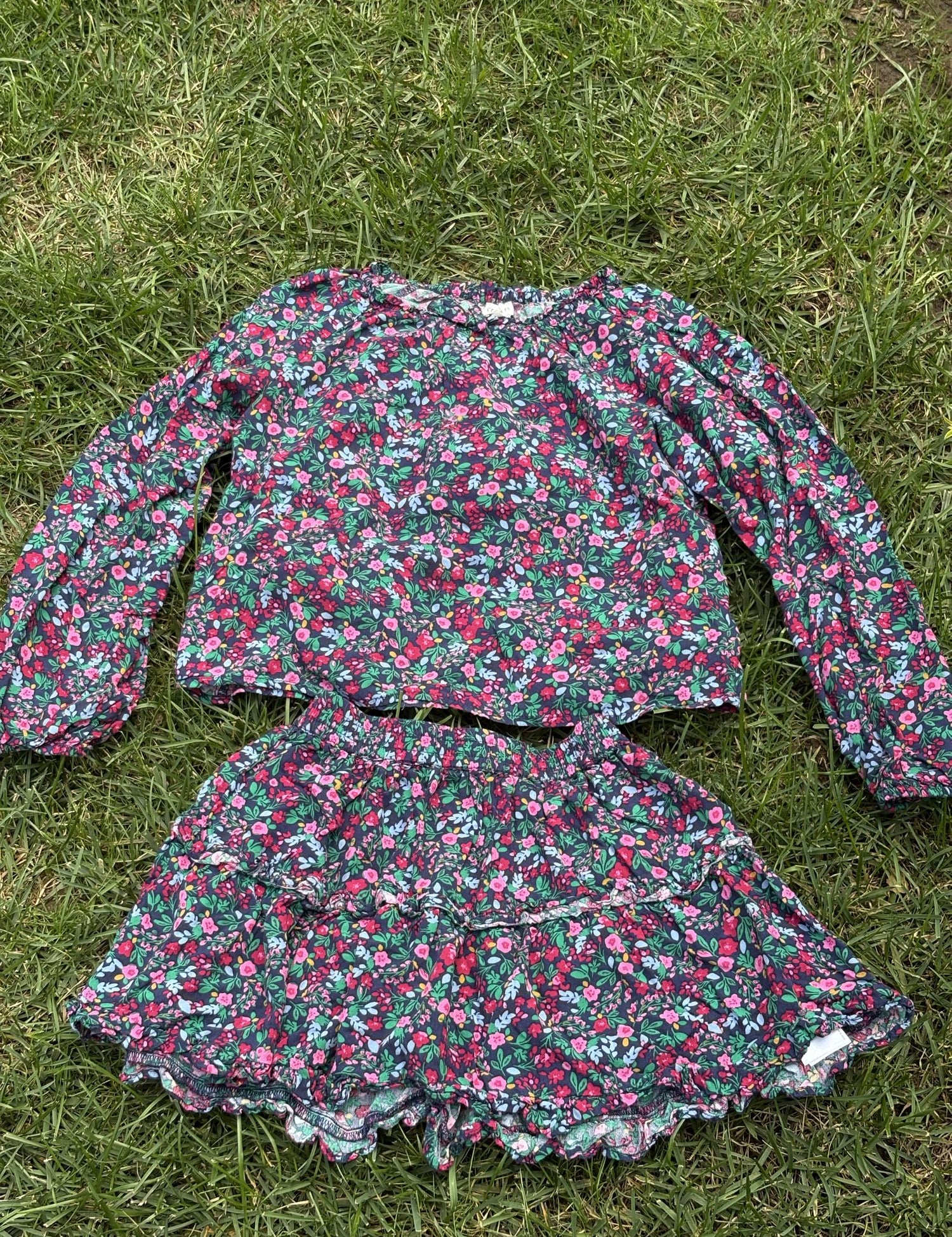 Pre-loved J.Crew green floral top and skirt set, kids size 10, front view, laid flat on grass