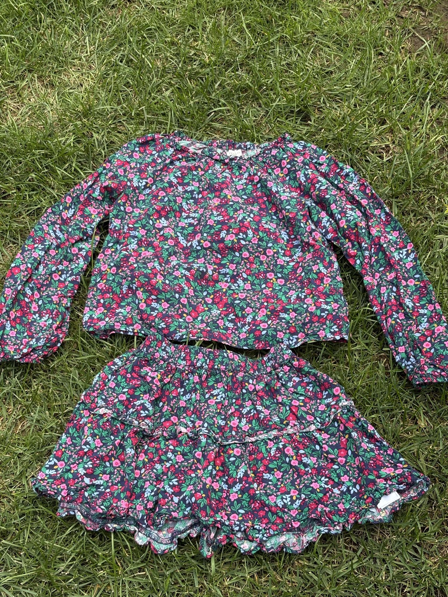 Pre-loved J.Crew green floral top and skirt set, kids size 10, front view, laid flat on grass