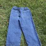 Pre-loved J.Crew wide-leg pull-on jeans, kids size 8, back view, laid flat on grass