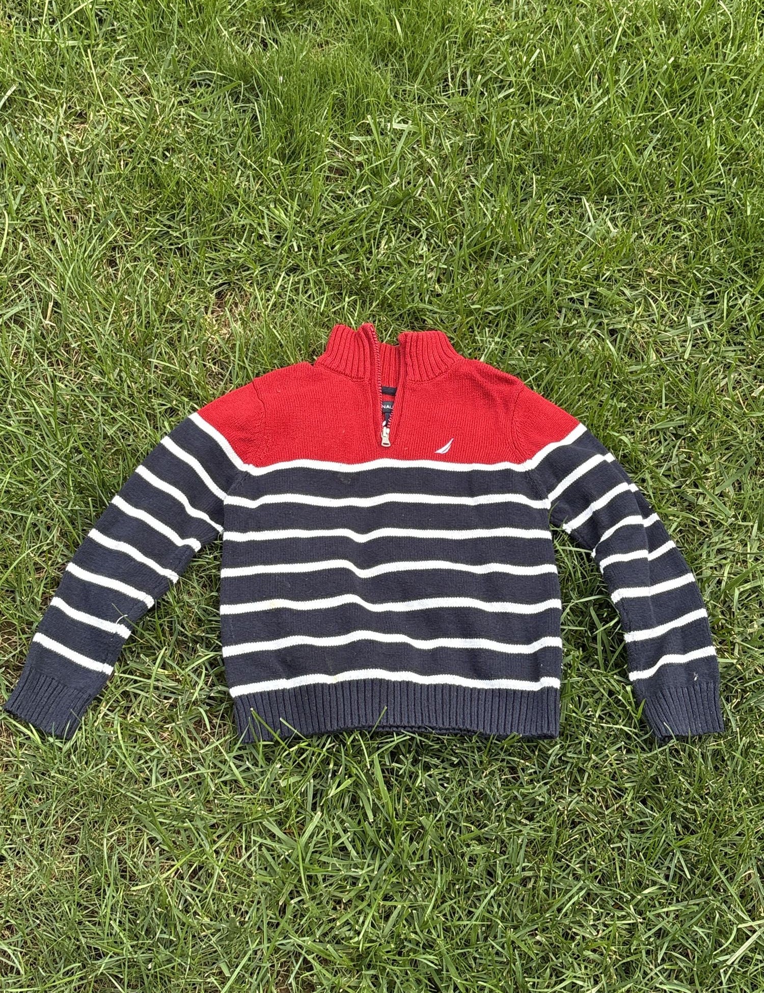 Pre-loved Nautica red and navy striped quarter-zip sweater, kids size 6, front view, laid flat on grass