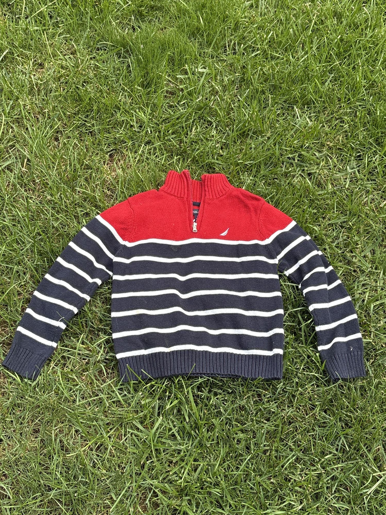 Pre-loved Nautica red and navy striped quarter-zip sweater, kids size 6, front view, laid flat on grass