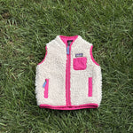 Pre-loved Patagonia cream retro-x fleece vest, kids size 12-18M, front view, laid flat on grass