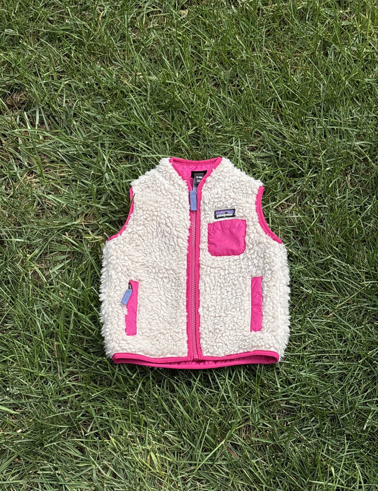 Pre-loved Patagonia cream retro-x fleece vest, kids size 12-18M, front view, laid flat on grass