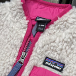 Pre-loved Patagonia cream retro-x fleece vest, kids size 12-18M, brand and size label close-up