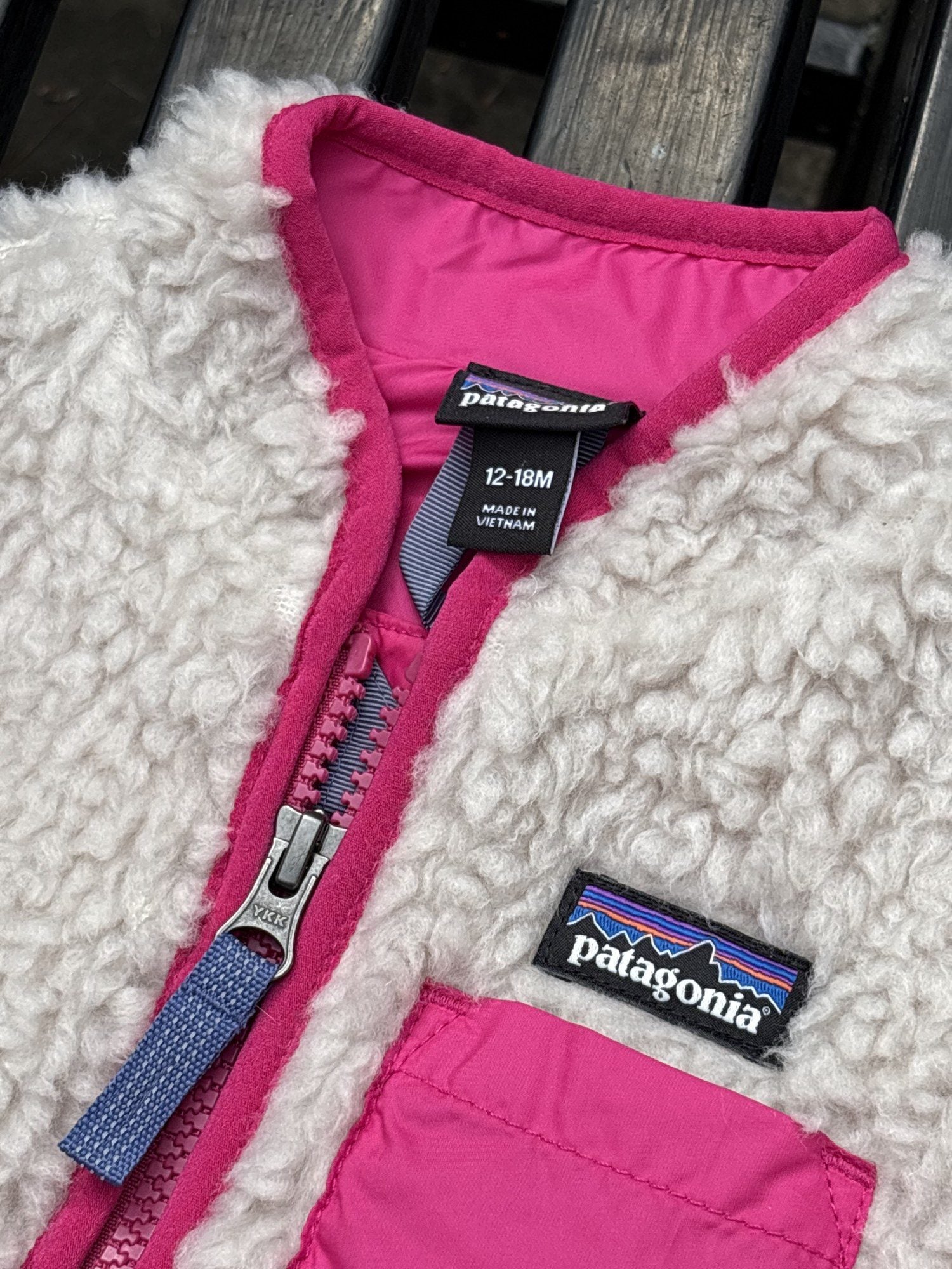 Pre-loved Patagonia cream retro-x fleece vest, kids size 12-18M, brand and size label close-up