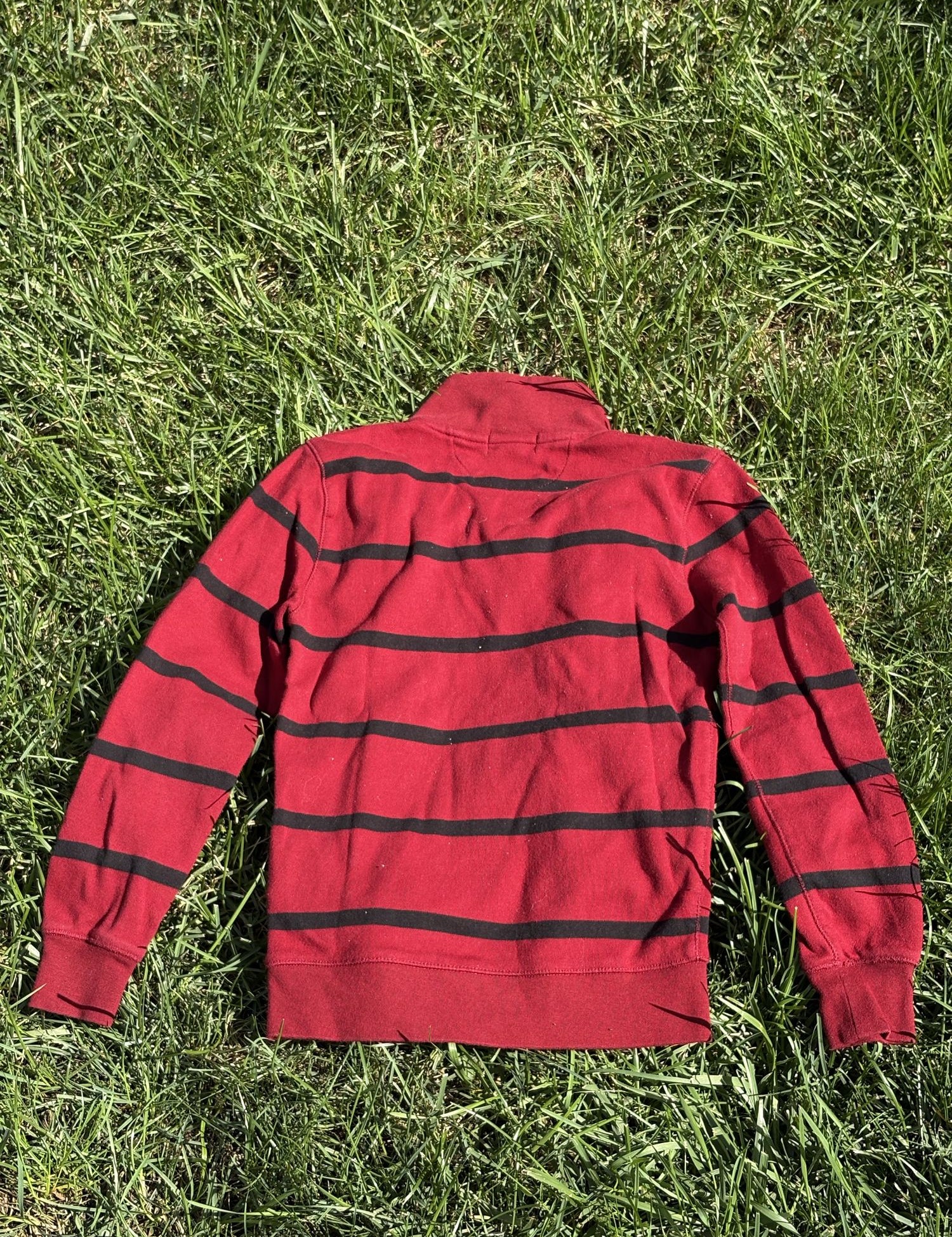 Pre-loved Ralph Lauren red striped quarter-zip pullover, kids size 7, back view, laid flat on grass