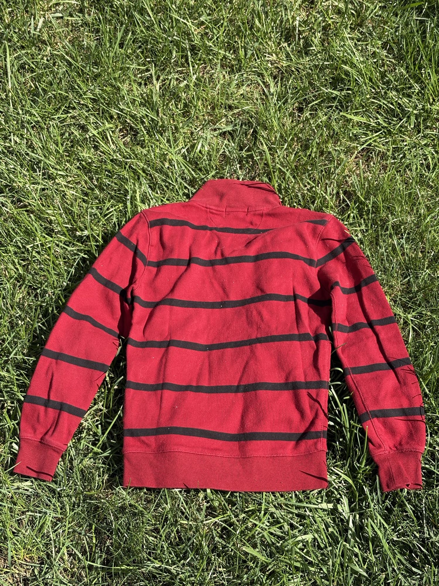 Pre-loved Ralph Lauren red striped quarter-zip pullover, kids size 7, back view, laid flat on grass