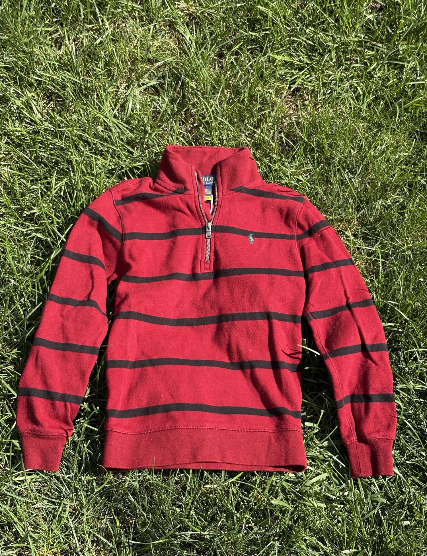 Pre-loved Ralph Lauren red striped quarter-zip pullover, kids size 7, front view, laid flat on grass