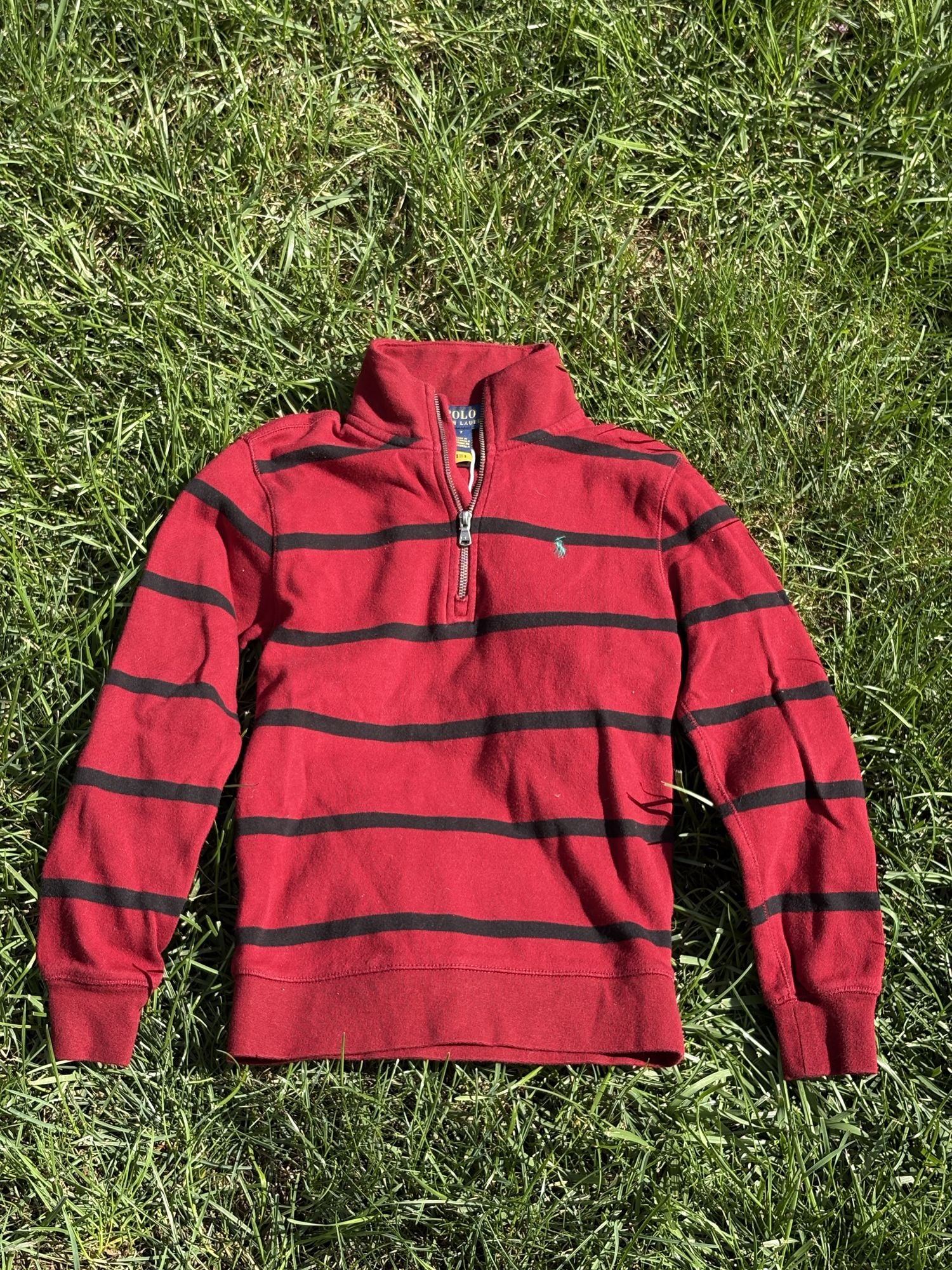 Pre-loved Ralph Lauren red striped quarter-zip pullover, kids size 7, front view, laid flat on grass