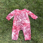 Pre-loved Red Egg & Ginger pink tie-dye gold star romper, kids size 3-6M, back view, laid flat on grass