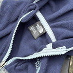 Pre-loved The North Face navy and gray full-zip fleece hoodie, kids size 3-6M, brand and size label close-up