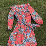 Pre-loved Ulla Johnson coral and blue botanical print dress, kids size 6, front view, laid flat on grass