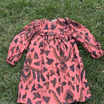 Pre-loved Ulla Johnson coral botanical print long-sleeve dress, kids size 4, front view, laid flat on grass